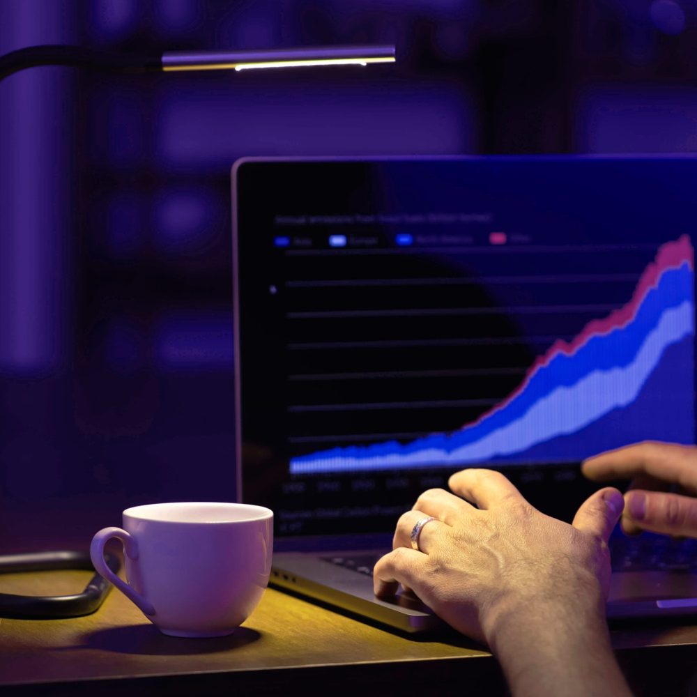 broker-looking-laptop-analyzing-stock-market-invest-trading-stocks-grap